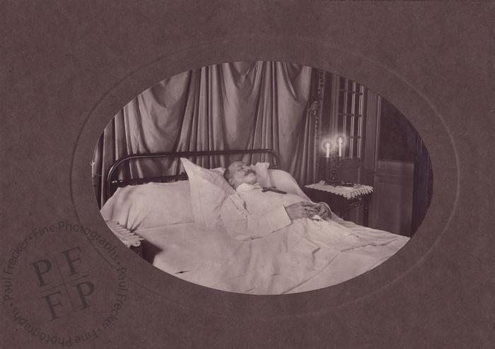Man on deathbed with candles