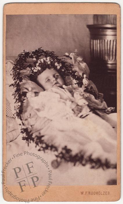 Infant wreathed in flowers