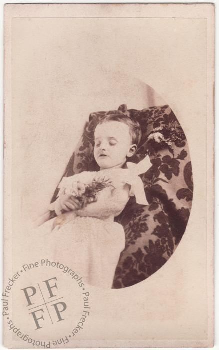 Infant with a posy of wildflowers 