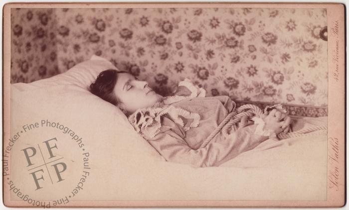 Woman with floral wallpaper