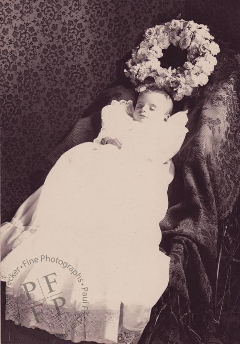 Baby with a wreath of flowers