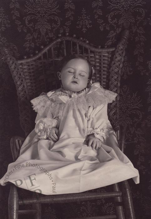Young girl in a wicker chair