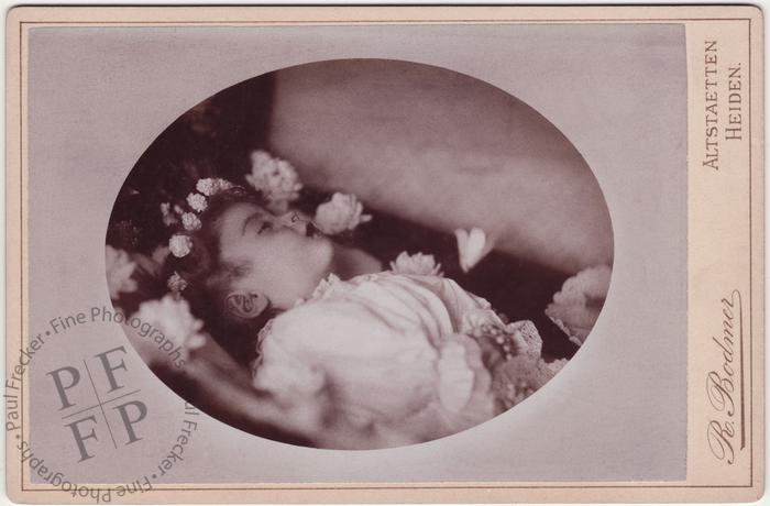 Child with a wreath of flowers