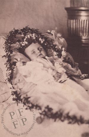 Infant wreathed in flowers