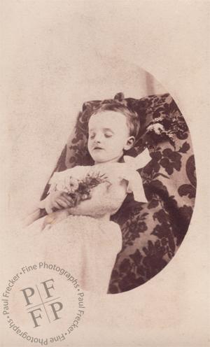 Infant with a posy of wildflowers 