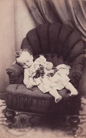 Bare-footed child on an armchair