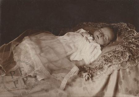 Baby on an ornate bedspread
