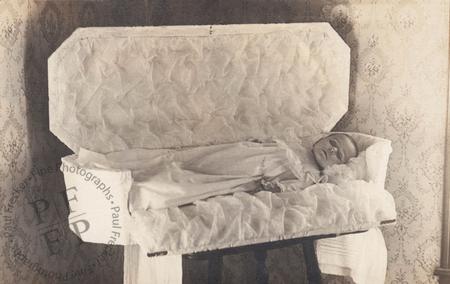 Baby in white coffin with drop panel side