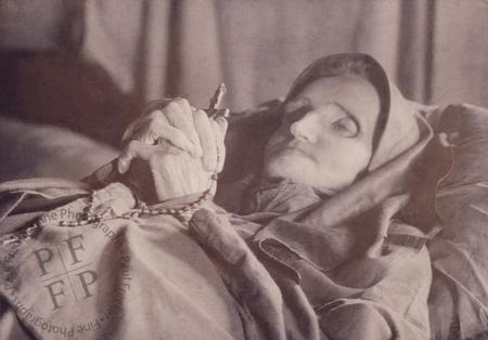Elderly woman with a rosary
