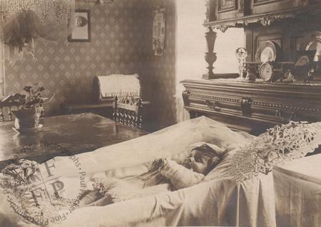 Infant laid out in a parlour