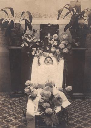 Young boy in an open coffin