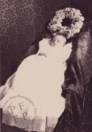 Baby with a wreath of flowers