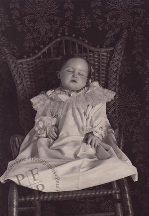 Young girl in a wicker chair